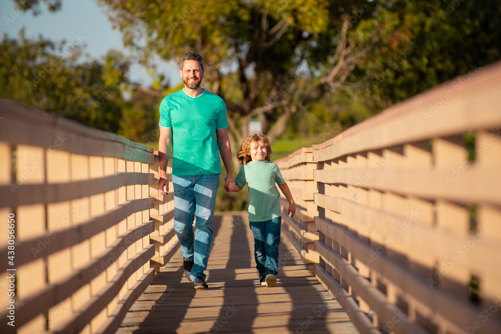 Concept of friendly family. Happy father and son. Dad and child playing outdoors. Happy family. Men generation. Concept of friendly family. Happy father and son. Dad and child playing outdoors. Happy family. Men generation.