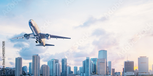 Tableau sur toile Airplane on beautiful city skyline and blue sky background