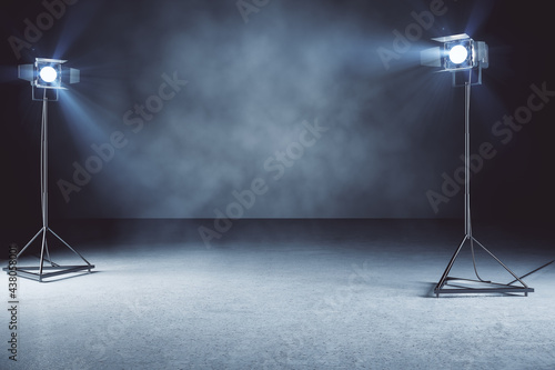 Creative concrete photo studio wallpaper with lamps and mockup place. 3D Rendering.
