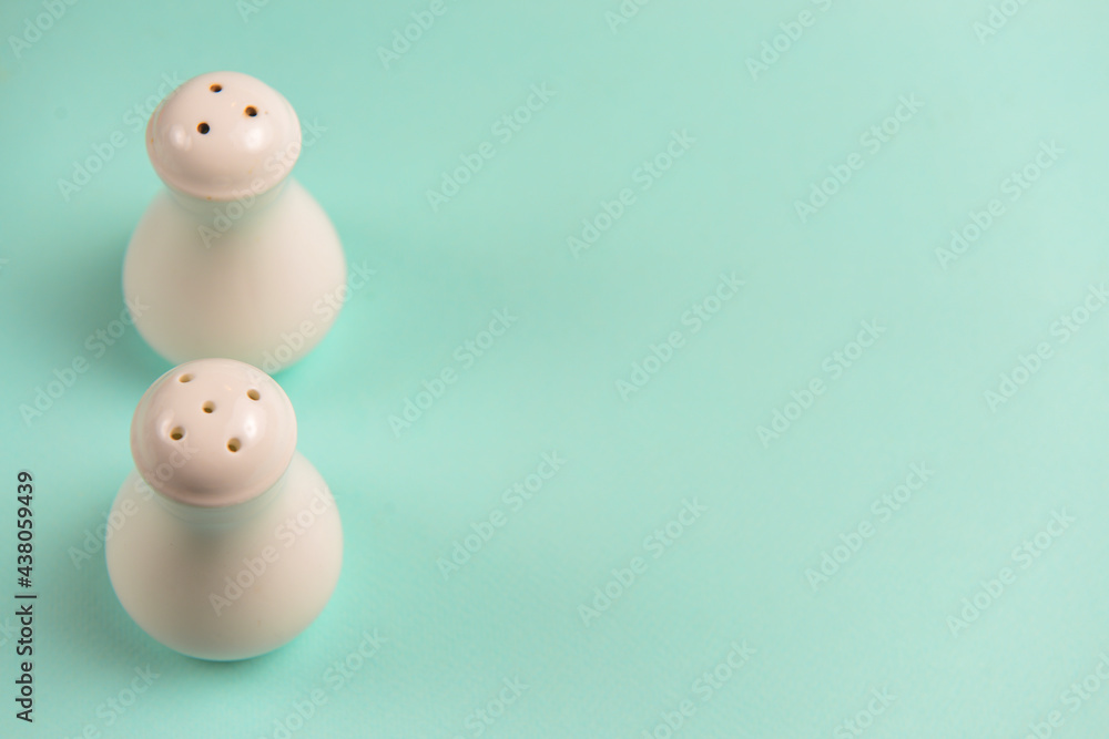 Salt and Pepper shaker isolated on pastel pink background. Copy space banner. Salt and Pepper shaker isolated on pastel pink background. Copy space banner.