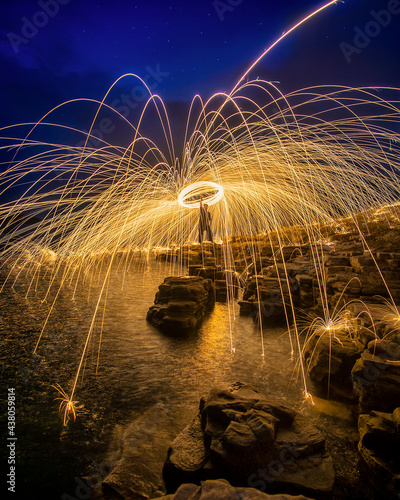 Steel wool photography on rocks nearby the lake