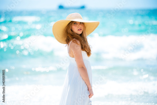 Fashion model posing on the beach. Summer dress fashionable woman clothes. Young beautiful hipster woman on tropical vacation, summer trend style.