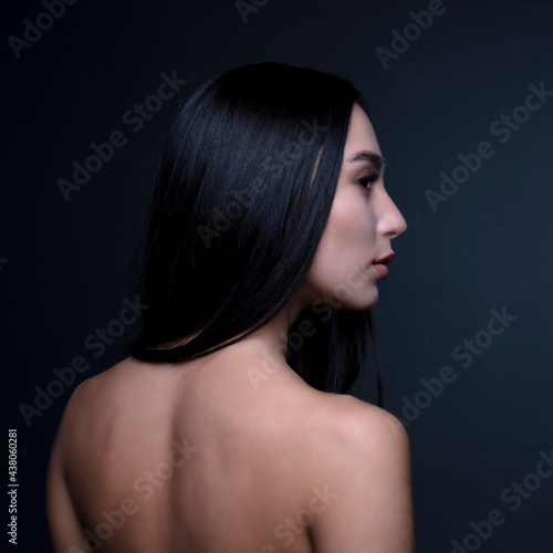 portrait of a young woman in the studio on a dark background