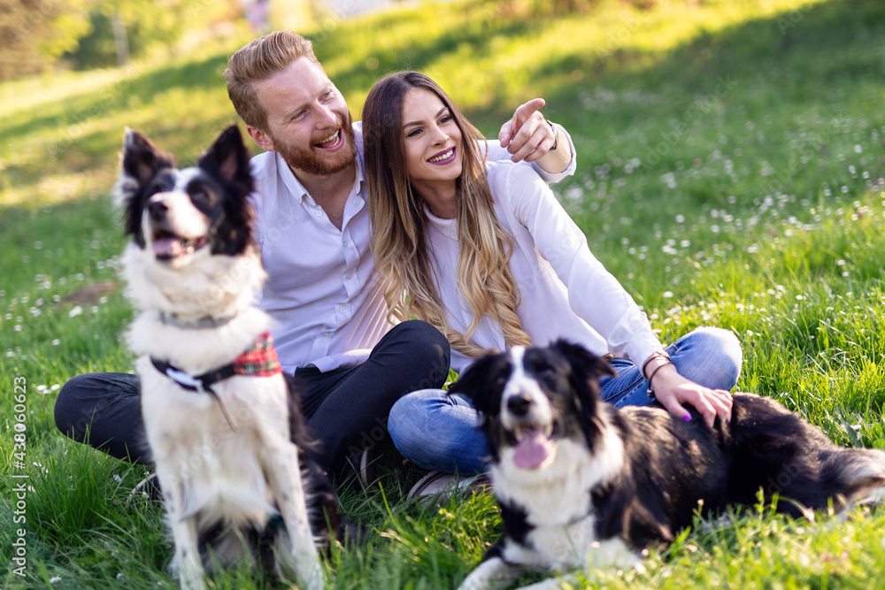 Romantic happy couple in love enjoying their time with pets in nature Romantic happy couple in love enjoying their time with pets in nature