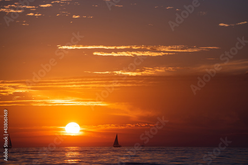 Seascape golden sunrise over the sea. Nature landscape. Beautiful orange and yellow color on ocean sunset. Seascape with gold sky and clouds.