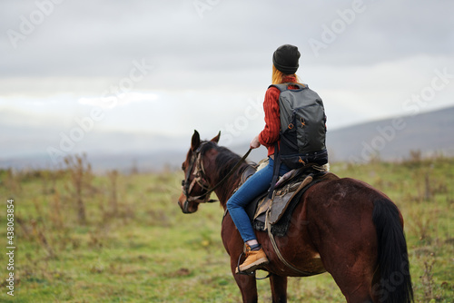 woman hiker with backpack riding horse travel freedom