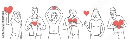 Smiling people holding hearts.