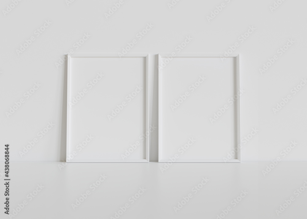 Two white frames leaning on white floor in interior mockup. Template of pictures framed on a wall 3D rendering Two white frames leaning on white floor in interior mockup. Template of pictures framed on a wall 3D rendering