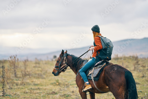 woman hiker riding horse travel mountains landscape