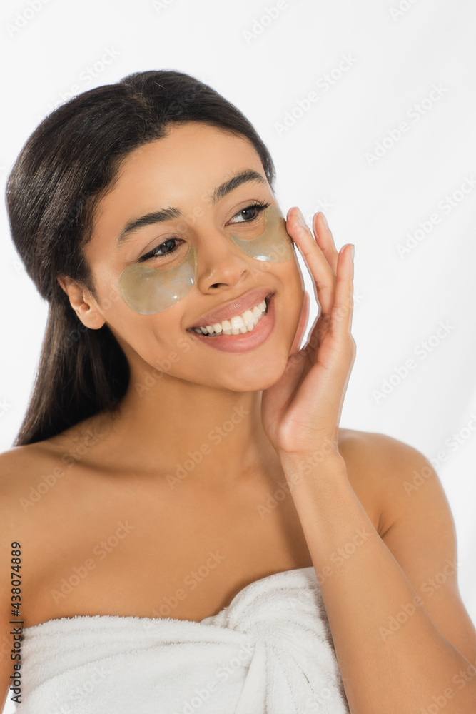 young african american woman holding hand near face with eye patches on white background young african american woman holding hand near face with eye patches on white background
