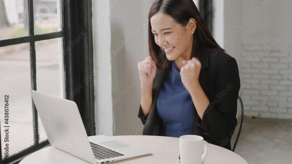 Yes! Happy excited successful, Asian businesswoman smile workstation triumphing with raised hands with laptop computer, woman success project online winner Yes! Happy excited successful, Asian businesswoman smile workstation triumphing with raised hands with laptop computer, woman success project online winner