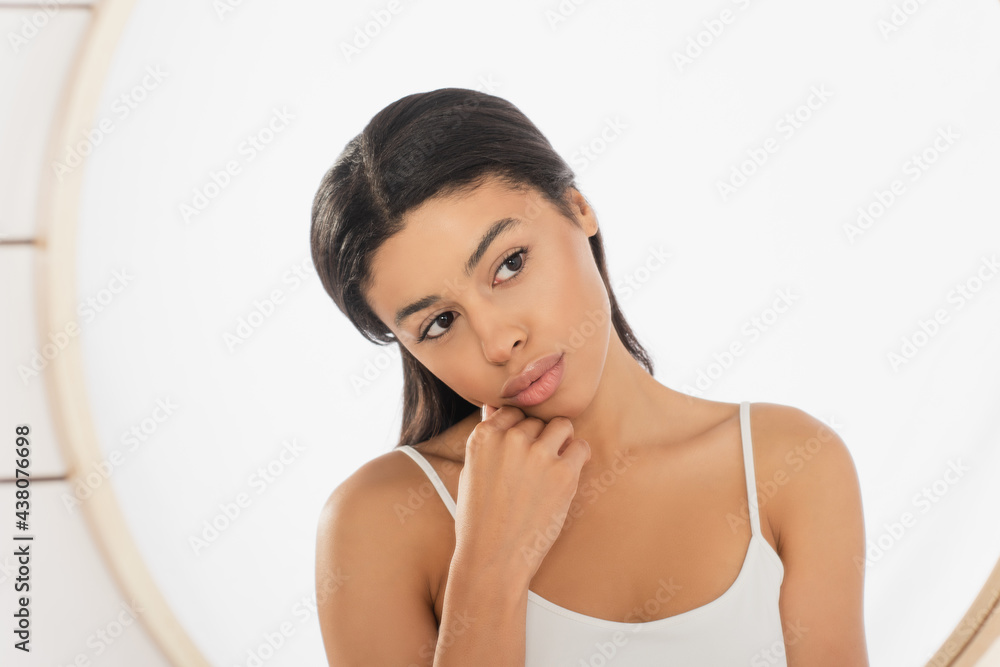 thoughtful young african american woman looking in mirror on white background thoughtful young african american woman looking in mirror on white background