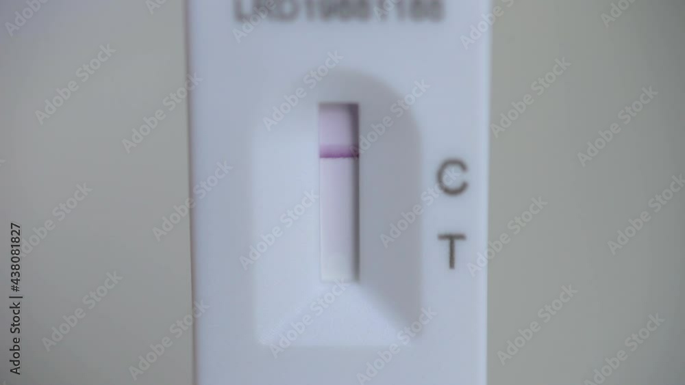 London, UK, June 1st 2021: Covid-19 rapid self test kit, provided by the NHS for free. A rapid antigen lateral flow device. Close-up showing a purple line for a negative result. Test and trace. London, UK, June 1st 2021: Covid-19 rapid self test kit, provided by the NHS for free. A rapid antigen lateral flow device. Close-up showing a purple line for a negative result. Test and trace.