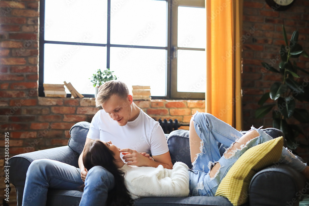 The couple is relaxing at home on a beautiful day and shooting The couple is relaxing at home on a beautiful day and shooting