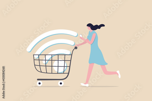 Mobile online shopping, app or website e-commerce website easy to buy and purchase products concept, happy young woman using mobile e-commerce app with big wifi sign in shopping cart trolley.
