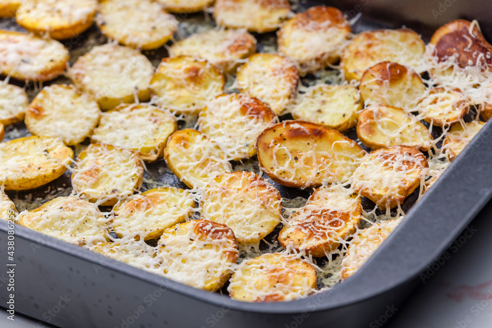 slices of potatoes baked with grated cheese slices of potatoes baked with grated cheese