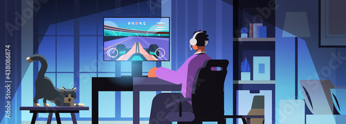 virtual gamer playing online video game on computer man in headphones sitting in front of monitor