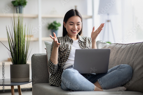Obraz na plátně Happy asian woman having video chat with her lover