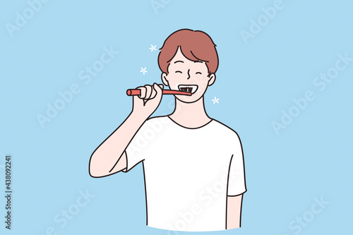 Dental health and hygiene concept. Young smiling child boy cartoon character standing and cleaning teeth with toothbrush brushing teeth with toothbrush vector illustration 