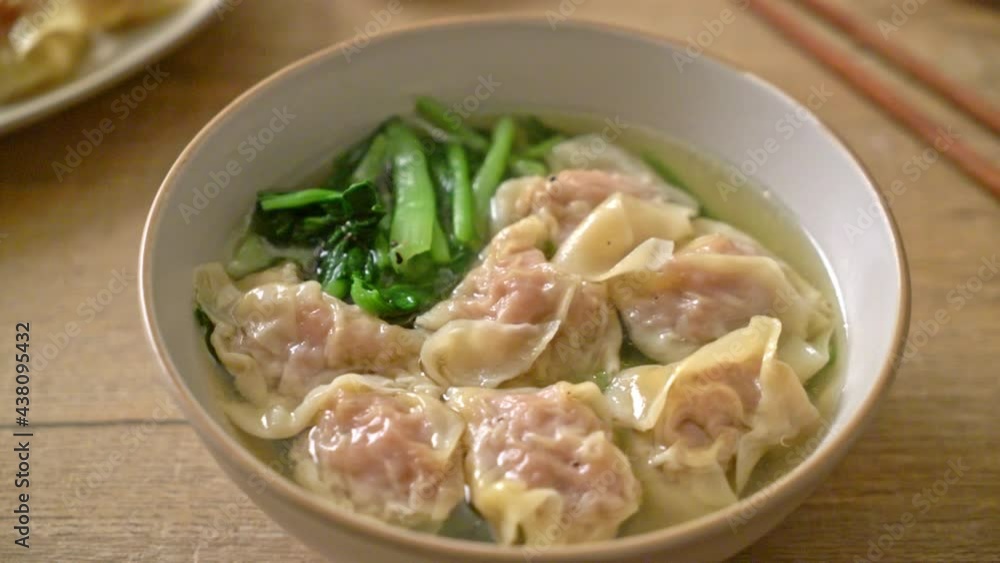 pork wonton soup or pork dumplings soup with vegetable - Asian food style pork wonton soup or pork dumplings soup with vegetable - Asian food style