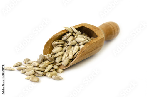 roasted and salted sunflower seeds with a wooden spoon