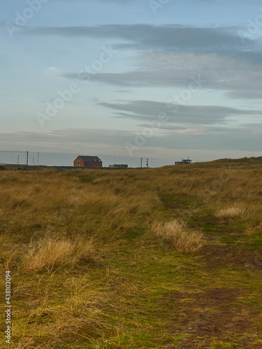 The lonely, stark landscape at South Gare - the wide flats of the slagfields, reclaimed by grasses, leading to isolated port buildings on the headland.