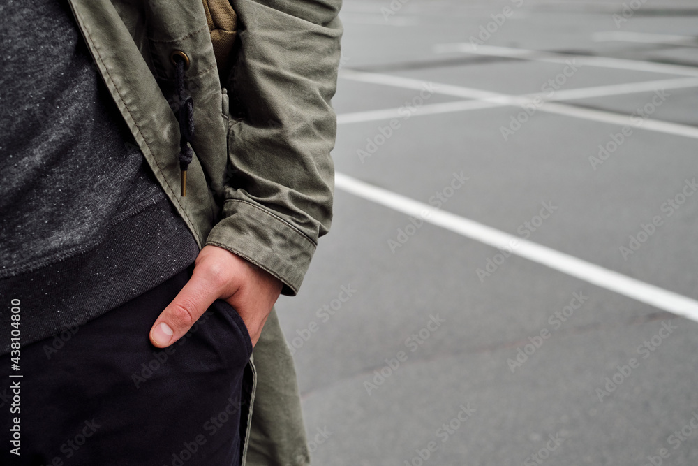 The man holds his hand in his pants pocket. Hand gestures of a confident person. Place for your text. Close-up hand The man holds his hand in his pants pocket. Hand gestures of a confident person. Place for your text. Close-up hand
