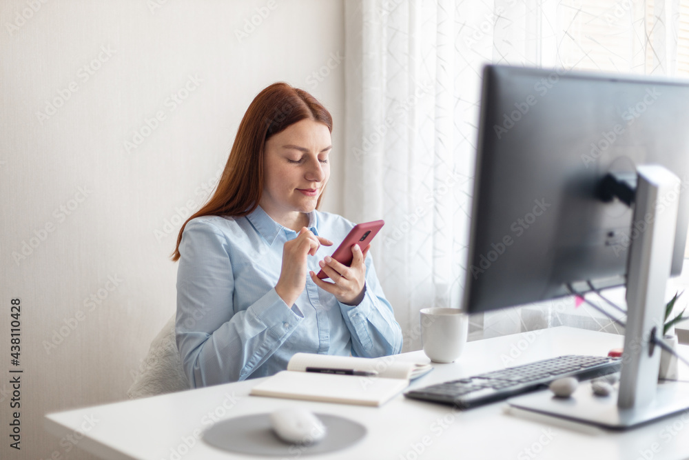 Young business woman using computer and smartphone at home at remote work. Young business woman using computer and smartphone at home at remote work.