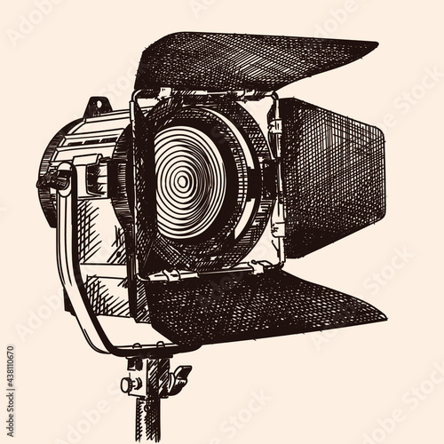 Constant light illuminator with curtains and fresnel lens on a stand for filming movies. The device is isolated on a beige background. photo