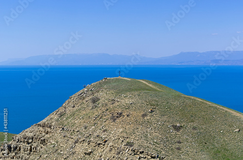 Orthodox cross on the top of the coastal mountain. Crimea. photo