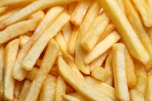 Yummy French fries as background, top view