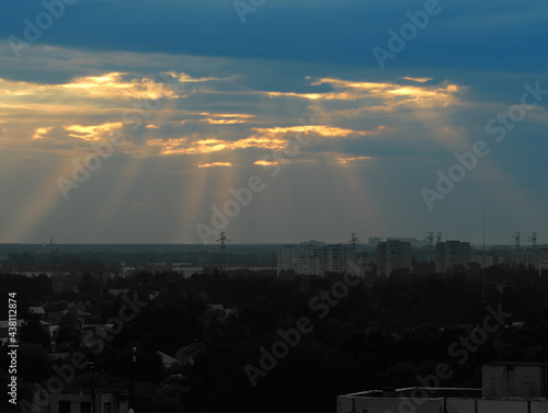 Sunset light rays over the city outskirts