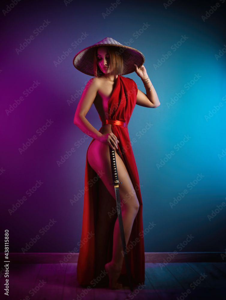 sexy woman in a red cape and an Asian hat with a katana in her hand image of a samurai in neon color sexy woman in a red cape and an Asian hat with a katana in her hand image of a samurai in neon color