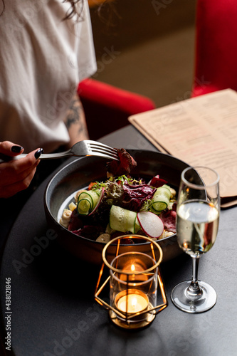 Fototapeta Naklejka Na Ścianę i Meble -  Champagne and gourmet salad in a posh restaurant, set table in an expensive restaurant interior