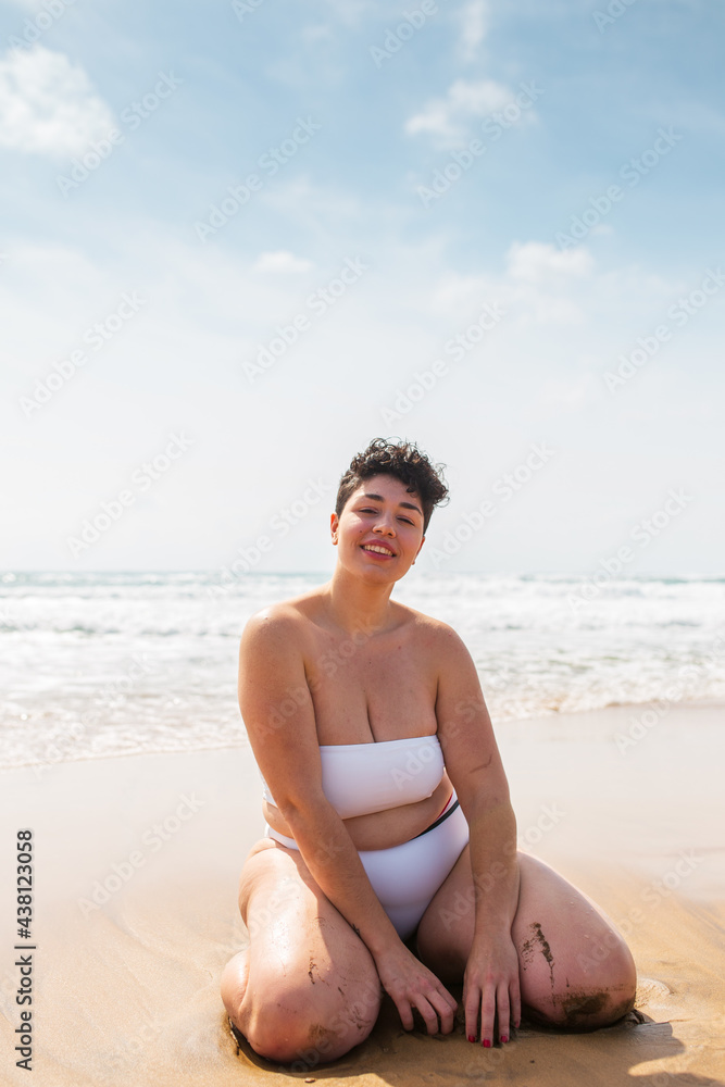 Lady sitting on sandy coast near sea Lady sitting on sandy coast near sea