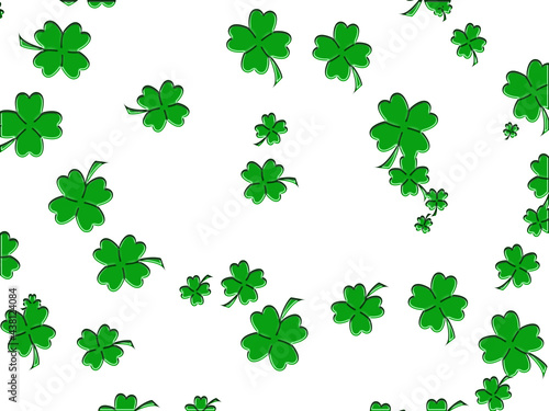 White background dotted with green clovers.