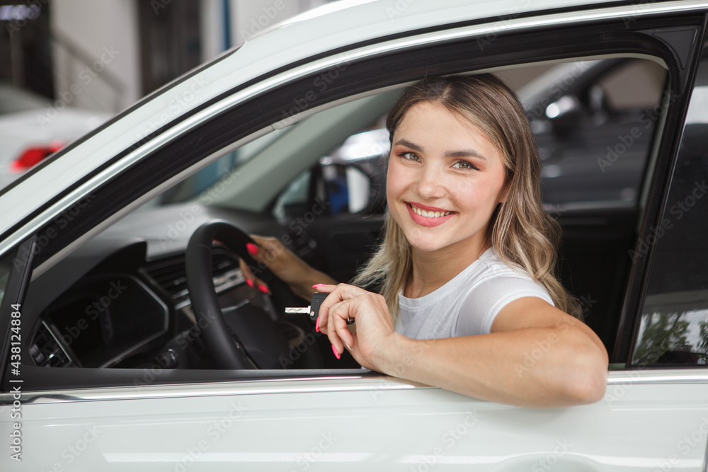 Attractive female driver smiling to the camera