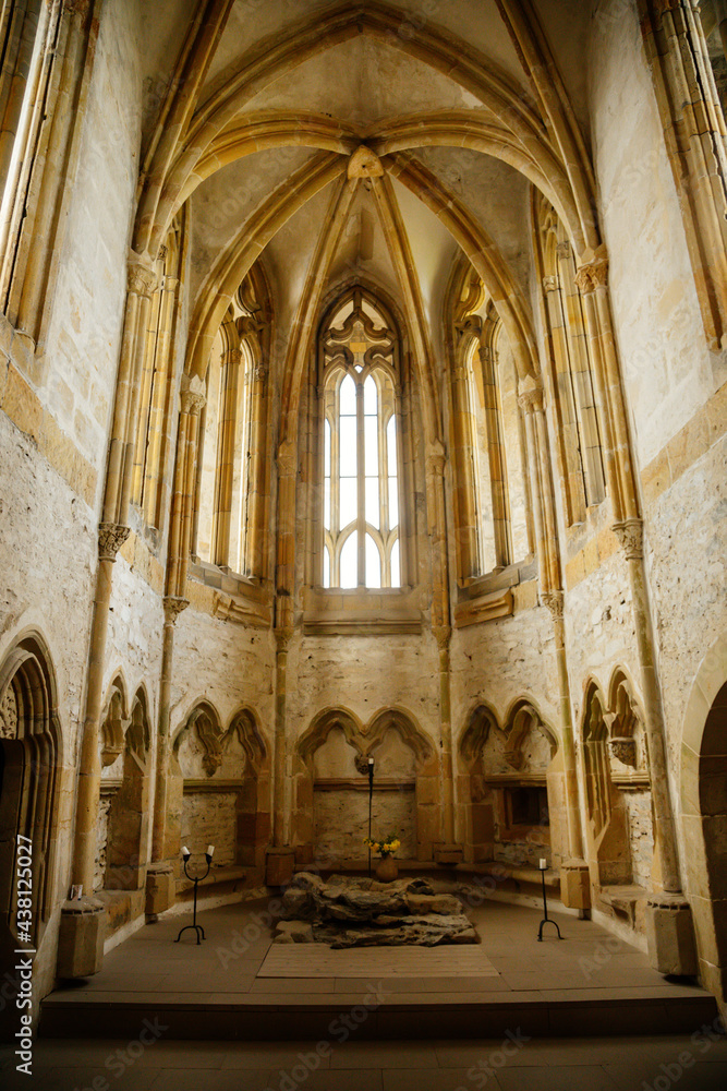 Interior of Chapel of St. Archangel Michael in medieval castle Bezdez, gothic arched windows in church, rib vault, altar part, stone carving, ruin on hill, North Bohemia, Czech Republic