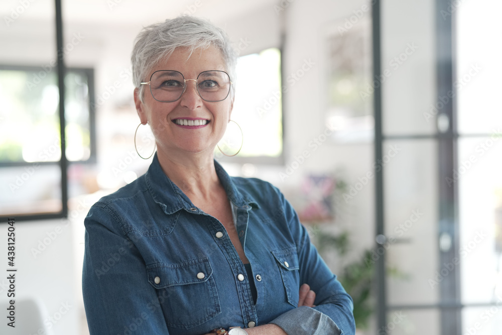 portrait of a 55 year old smiling senior woman in her home portrait of a 55 year old smiling senior woman in her home