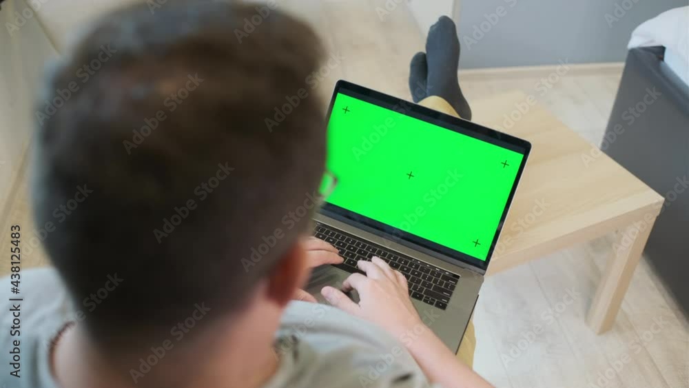 Unrecognizable man using laptop at home Unrecognizable man using laptop at home
