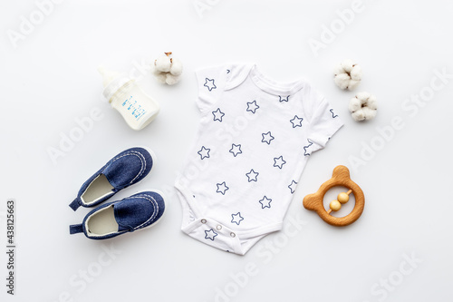 Baby accessories with bodysuit and shoes. Flat lay