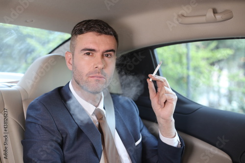 Careless businessman smoking in backseat © ajr_images