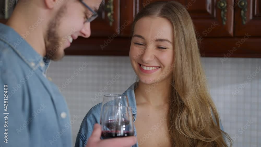 Charming young Caucasian woman looking with love at man toasting clinking wine glasses and drinking alcohol. Portrait of happy smiling girlfriend celebrating anniversary Valentine's Day with boyfriend Charming young Caucasian woman looking with love at man toasting clinking wine glasses and drinking alcohol. Portrait of happy smiling girlfriend celebrating anniversary Valentine's Day with boyfriend