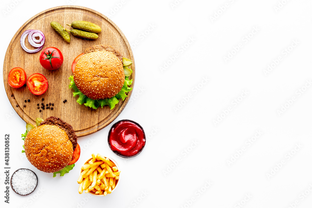 Hamburgers with vegetales and french fries. Top view Hamburgers with vegetales and french fries. Top view