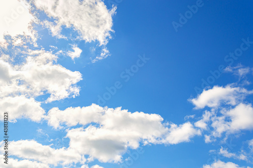Blue sky background. White clouds in the bright clear sky.
