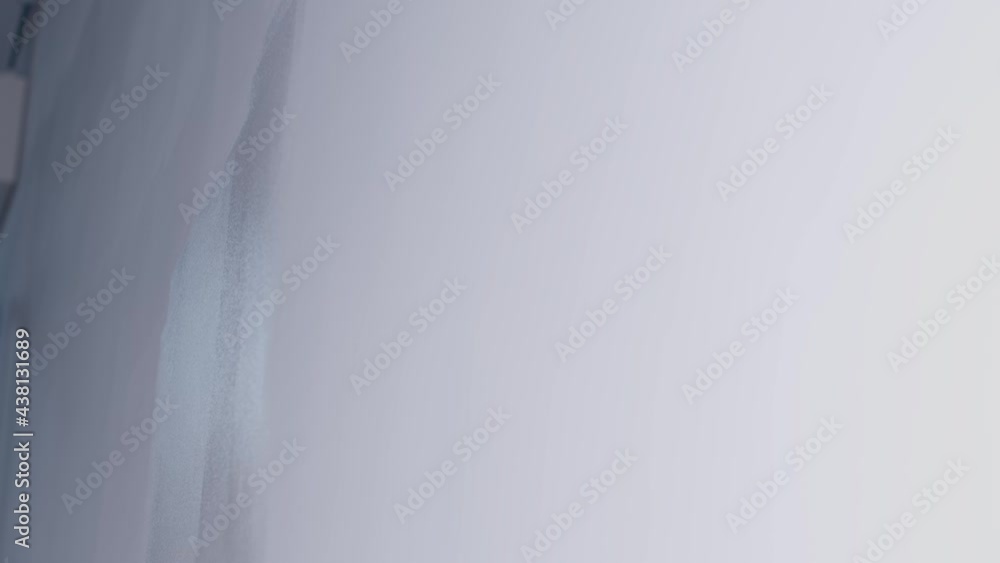 Low Angle Pedestal Shot Looking Up at Paint Roller Applying White Paint to Wall Low Angle Pedestal Shot Looking Up at Paint Roller Applying White Paint to Wall