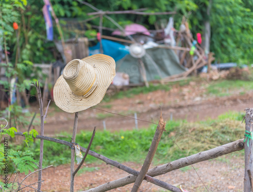 Farmer's Hat hanging on a wooden fence