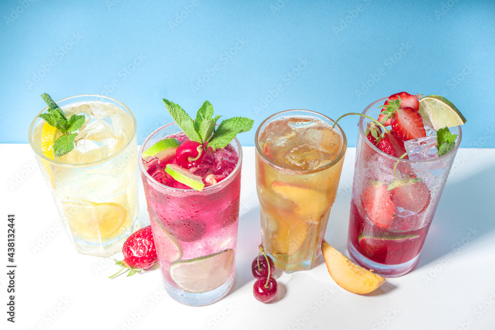 Iced refreshing drink. Bar and caffee beverage menu background. Set of various cold summer cocktails - peach tea, lemonade, mojito, cherry mocktail, with frruits on colorful bright blue background Iced refreshing drink. Bar and caffee beverage menu background. Set of various cold summer cocktails - peach tea, lemonade, mojito, cherry mocktail, with frruits on colorful bright blue background