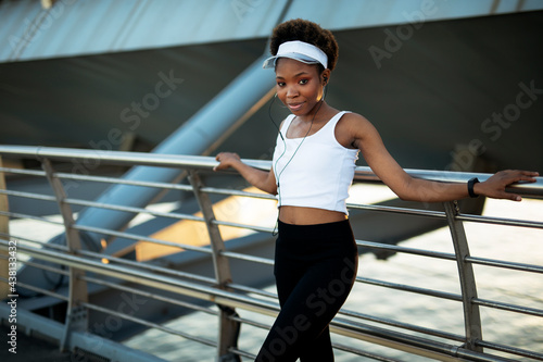 Sporty woman training outdoors. Young african woman in sportswear.