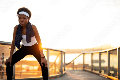 Sporty woman training outdoors. Young african woman in sportswear.